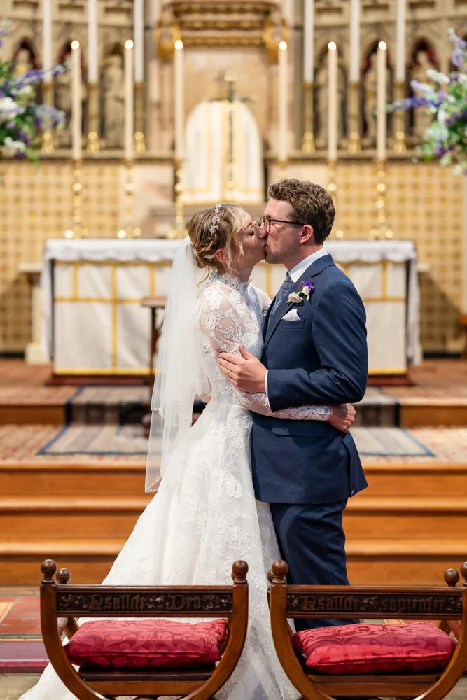 Oxford Oratory wedding photographer. Bride and groom first kiss.
