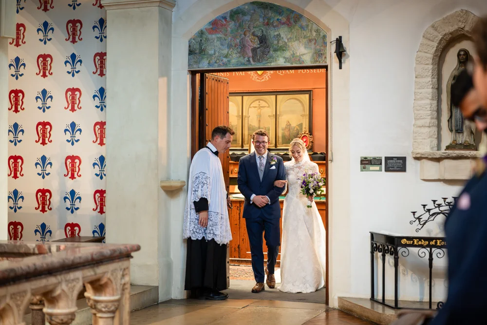 Oxford Oratory wedding photographer. Bride and groom leaving wedding ceremony.