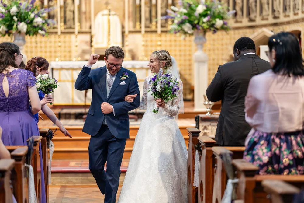 Oxford Oratory wedding photographer. Bride and groom leaving wedding ceremony.
