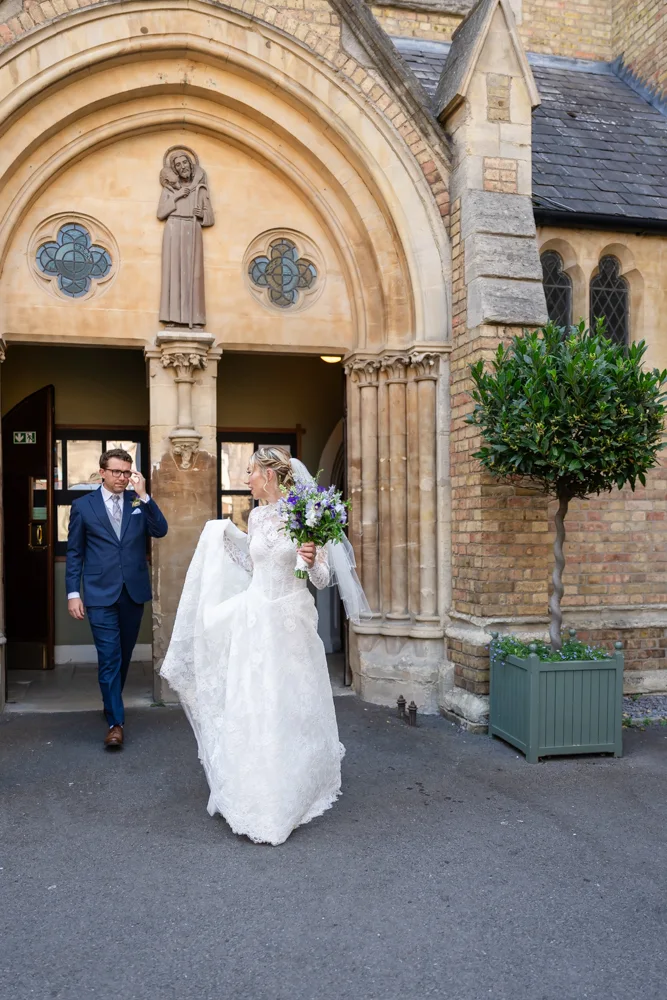 Oxford Oratory wedding photographer. Bride and groom leaving wedding ceremony.