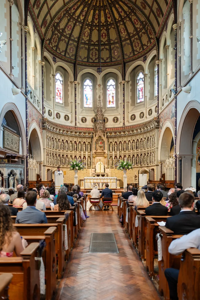 Oxford Oratory wedding photographer. Bride and groom during wedding ceremony.