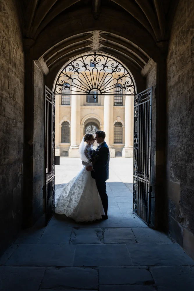 Oxford University wedding photographer. Bride and groom silhouette with Clarendon Building in background