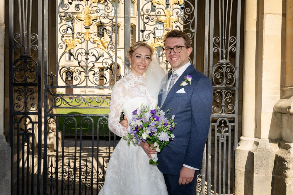 Oxford University wedding photographer. Bride and groom in front of gates of All Souls College Oxford.