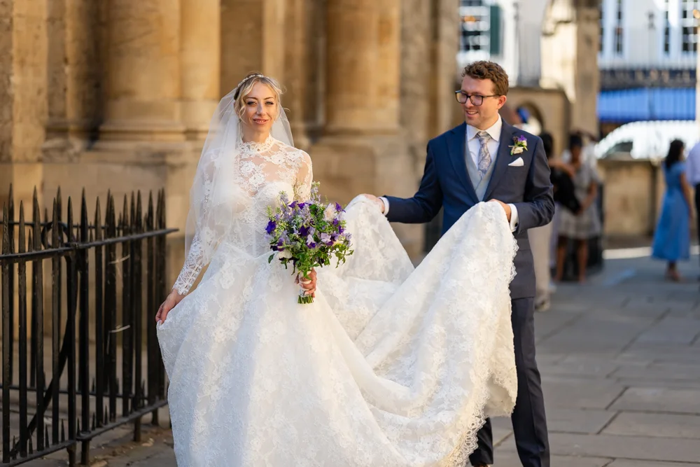 Oxford University wedding photographer. Bride and groom walking to the Divinity School Bodleian Library.