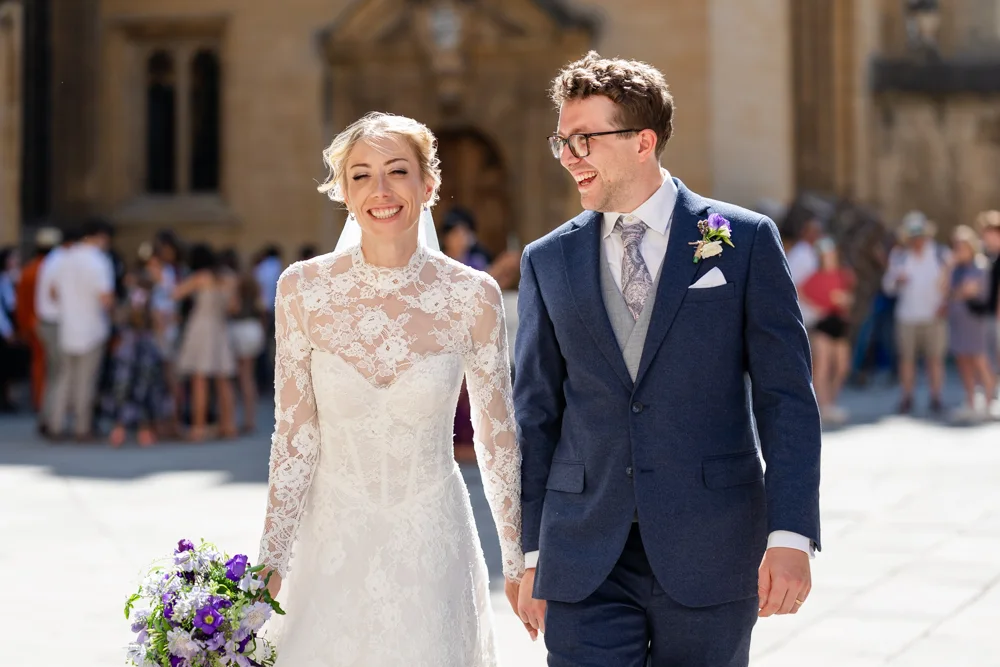 Wedding in Oxford. Bride and groom in gardens of New College Oxford with morning sun.