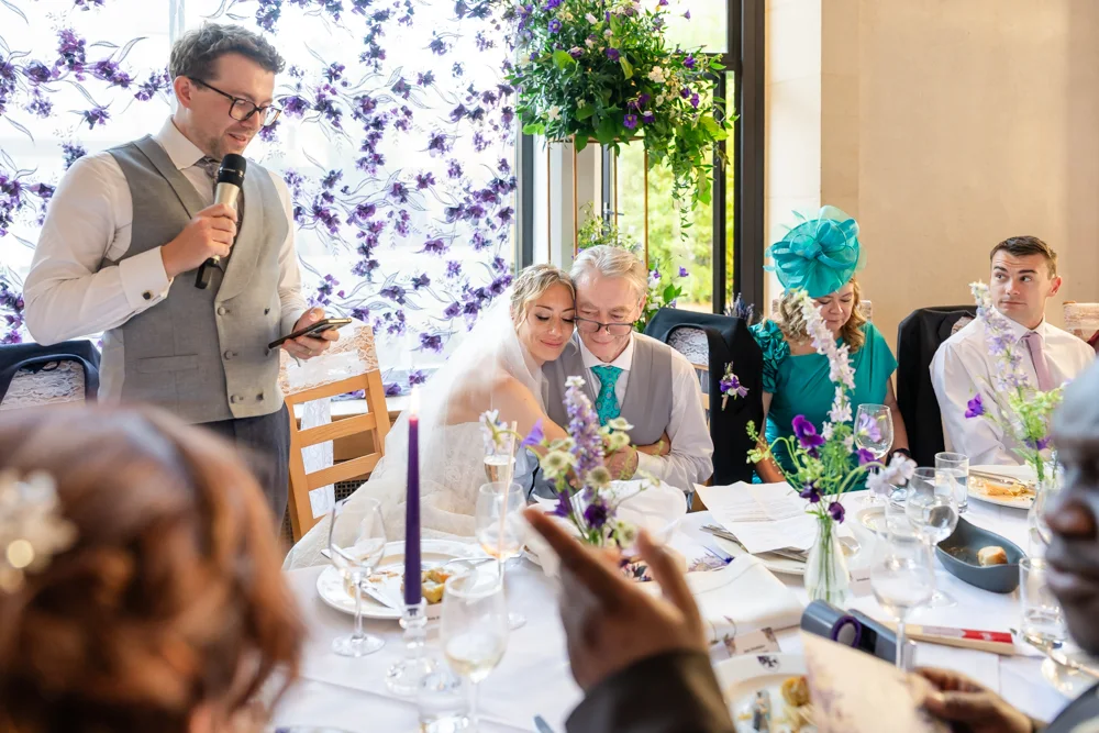 St Cross College wedding photographer. Bride and groom listening to speeches.
